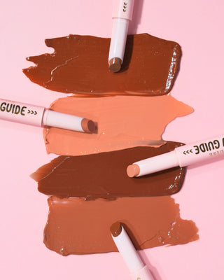 Swatches of the P.Louise Glow Guide Glossy Lipstick Balms on a pink background