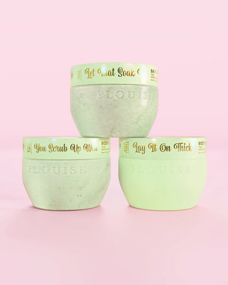 Three P.Louise Hop Into Self-Care Chocolate Covered Strawberries green containers featuring bath salts, body scrub and body butter with gold text on a pink background