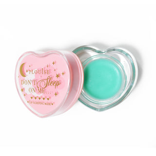 Pink heart-shaped lip sleeping mask with the lid off on a white background