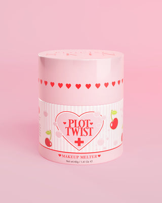 A pink container of P.Louise Plot Twist Makeup Melting Cleansing Balm with heart and cherry designs on the label against a pink background