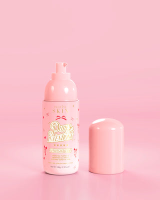 Pink bottle of P.Louise Pure Intentions Purify & Brightening Lotion with red bow designs against a pink background