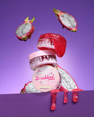 Jar of P. Louise All Scrubbed Up Scrubbed Up body scrub with dragon fruit on a purple background