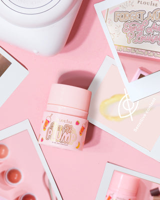 Pink bottle of P.Louise Pass The Plump Lip Treatment on a pink background